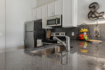 a kitchen with stainless steel appliances and a sink